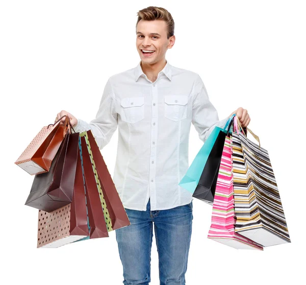 Retrato de joven feliz hombre sonriente con bolsas de compras — Foto de Stock