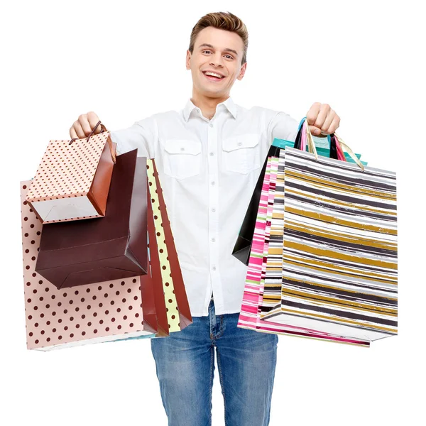 Retrato de joven feliz hombre sonriente con bolsas de compras — Foto de Stock