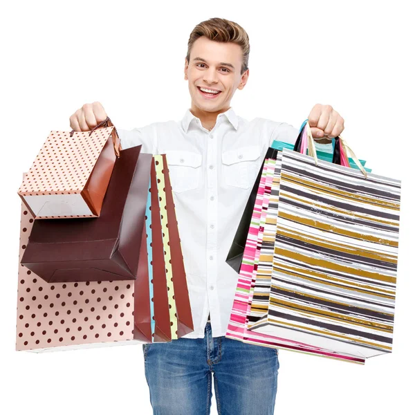 Retrato de joven feliz hombre sonriente con bolsas de compras — Foto de Stock