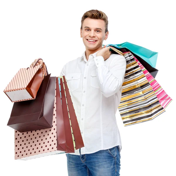 Retrato de joven feliz hombre sonriente con bolsas de compras — Foto de Stock