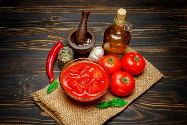 Tomato sauce or puree on wooden table — Stock Photo, Image