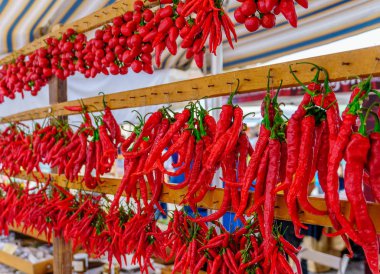 Rows of chilli peppers hang together clipart