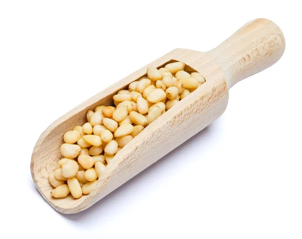 Scoop full of Roasted pine nuts isolated on white background. Clipping path — Stock Photo, Image