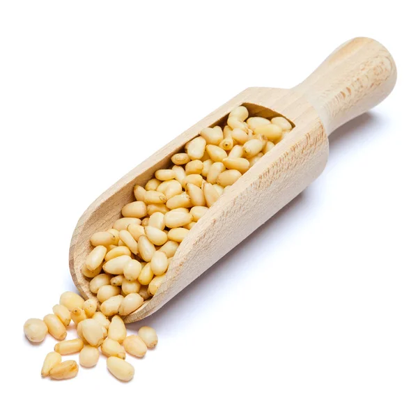 Scoop full of Roasted pine nuts isolated on white background. Clipping path — Stock Photo, Image