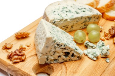 blue cheese on wooden cutting board clipart