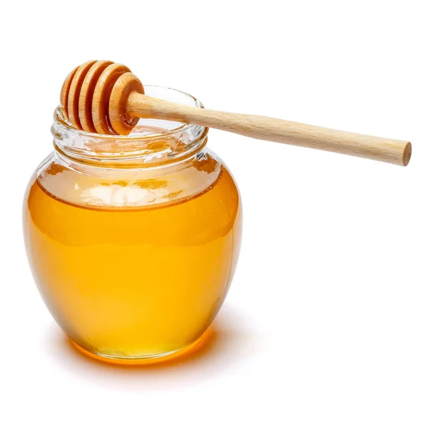Glass can full of honey and wooden stick on a white background. clipping path Stock Image