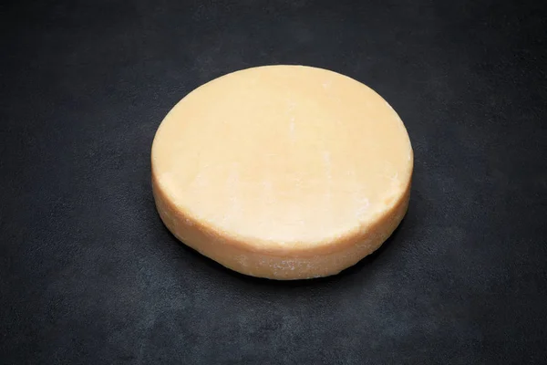Celá kola vedoucí parmazán nebo parmigiano tvrdý sýr na konkrétní pozadí — Stock fotografie