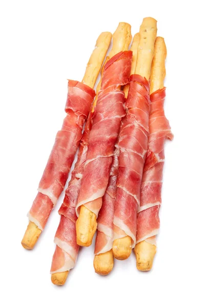 Bread sticks grissini with prosciutto isolated on white background — Stock Photo, Image