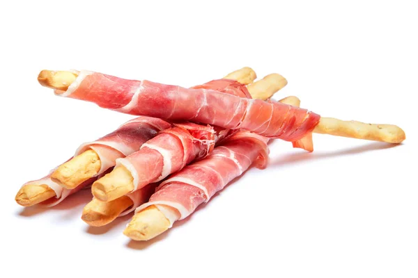 Bread sticks grissini with prosciutto isolated on white background — Stock Photo, Image