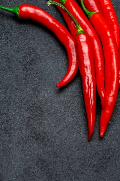 Sötét beton alapon piros chili paprika — Stock Fotó