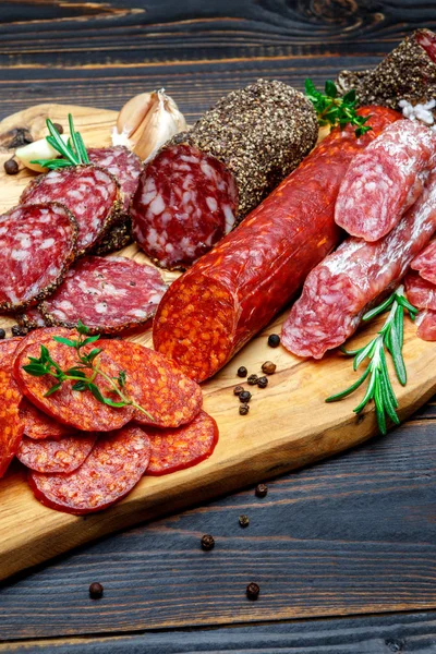 Salchicha de salami orgánica seca en tabla de cortar de madera — Foto de Stock