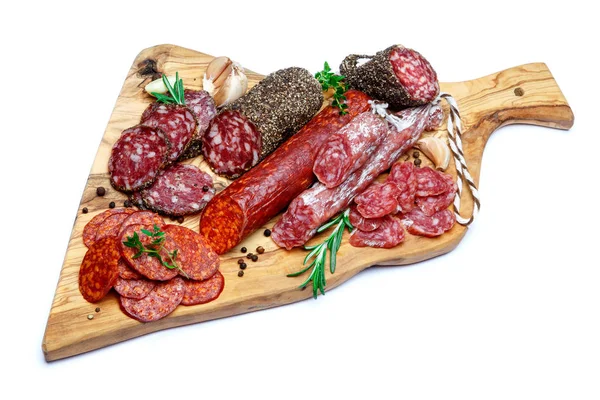 Various types of Dried organic salami sausage on wooden cutting board — Stock Photo, Image