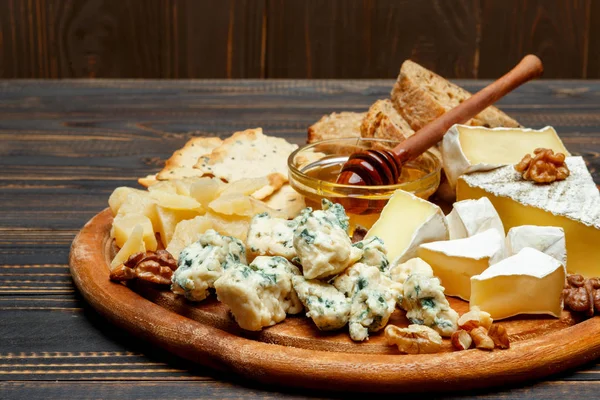 Сыр Бри на деревянной доске с хлебом и сладким мёдом — стоковое фото