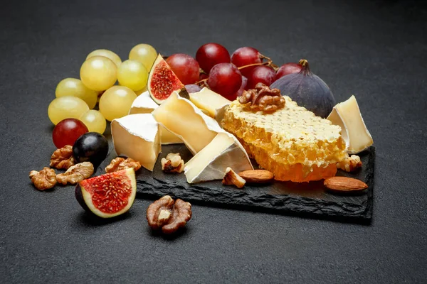 Queso camembert con miel, higos, nueces sobre tabla de piedra — Foto de Stock