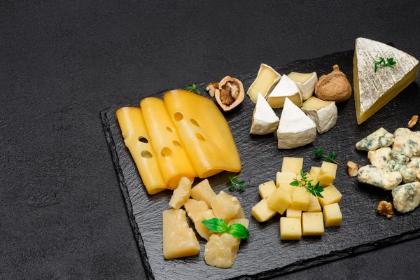 Vários tipos de queijo - brie, camembert, roquefort e cheddar em concreto — Fotografia de Stock