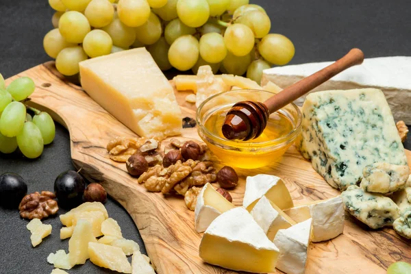 Vari tipi di formaggio brie, camembert, roquefort e cheddar e vino — Foto Stock