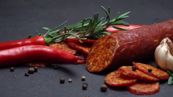 Salami and chorizo sausage close up on dark concrete background — Stock Video