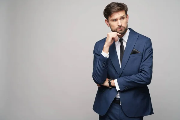 Studuo shot of thinking businessman wearing suit — Stock Photo, Image