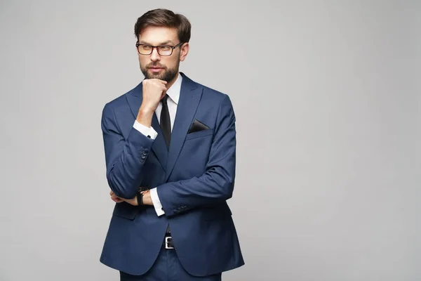 Studuo shot of thinking businessman wearing suit — Stock Photo, Image