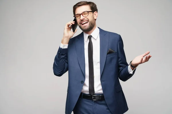 Empresário falando no telefone isolado sobre fundo cinza — Fotografia de Stock