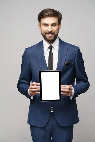 Ung affärsman presenterar digital tablet pc pad med tom skärm — Stockfoto