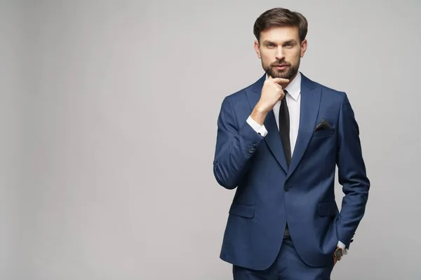 Studuo shot of thinking businessman wearing suit — Stock Photo, Image