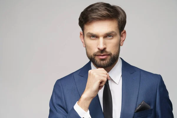 Studuo shot of thinking businessman wearing suit — Stock Photo, Image