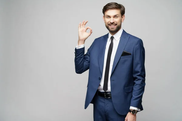 Portrait of a young businessman pointing on a copyspace with his finger — Stock Photo, Image