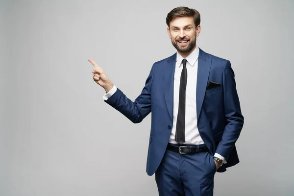 Portrait of a young businessman pointing on a copyspace with his finger — Stock Photo, Image