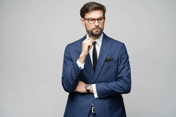 Studuo shot of thinking solving problem businessman wearing suit holding pen — Stock Photo, Image