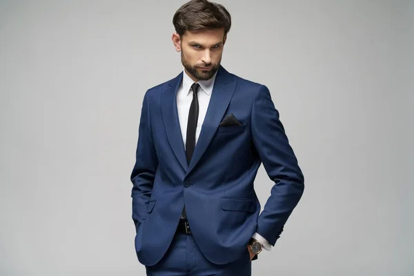 Studio photo of young handsome businessman wearing suit — ストック写真