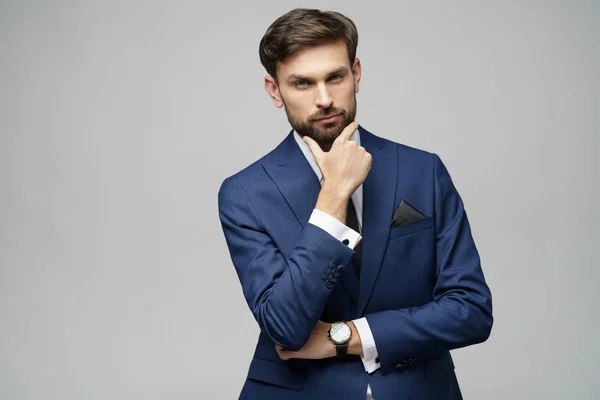 Studuo shot of thinking businessman wearing suit — Stock Photo, Image