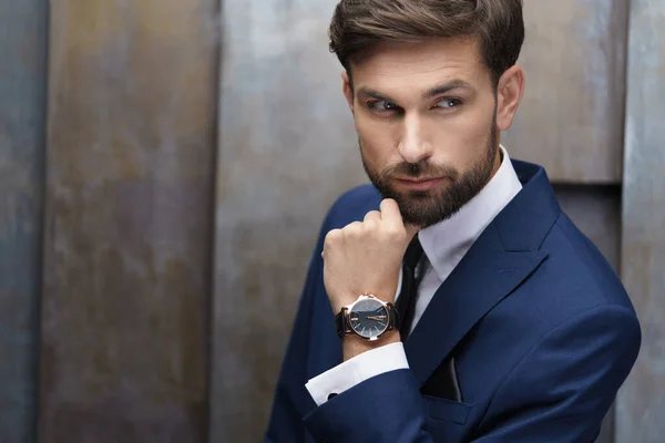 Indoor photo of young handsome stylish businessman wearing suit — Stock Photo, Image