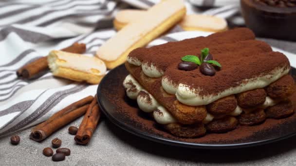 Sobremesa tiramisu clássico e biscoitos savoiardi em placa cerâmica sobre fundo de concreto — Vídeo de Stock