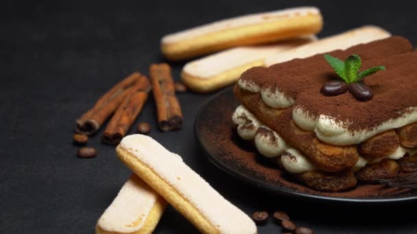 Classic tiramisu dessert on ceramic plate and savoiardi cookies on concrete background — Stock Video