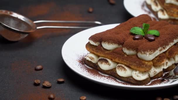Two portions of Classic tiramisu dessert on ceramic plate on concrete background — Stock Video