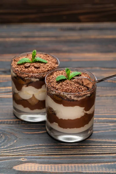 Classic tiramisu dessert in a glass cup on wooden background — Stock Photo, Image