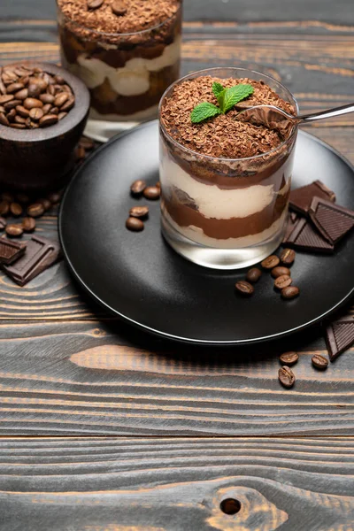 Classic tiramisu dessert in a glass cup on wooden background — Stockfoto