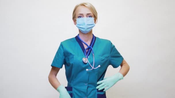 医療看護師の女性は保護マスクとラテックス手袋を身に着けています-大きな親指を表示 — ストック動画