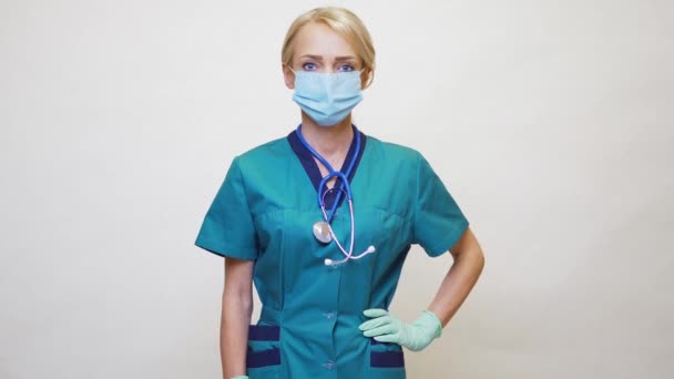 Medical doctor nurse woman wearing protective mask and latex gloves - showing at empty copy space — Stock Video