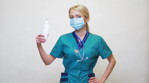 Medical doctor nurse wearing protective mask - holding sanitizing spray or gel or liquid soap — Stock Video