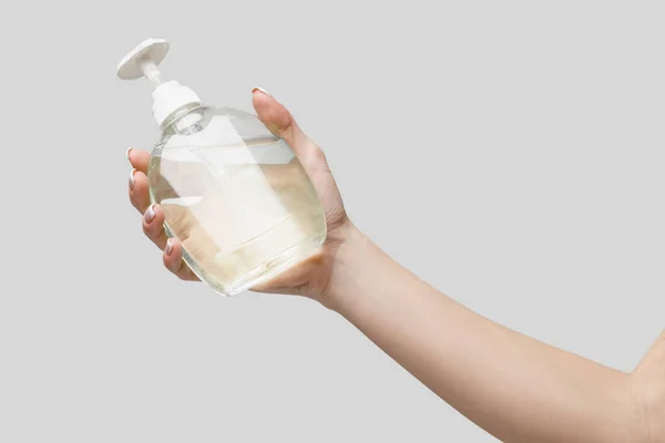 Female hands using hand sanitizer gel or liquid soap dispenser over light grey background — Stock Photo, Image