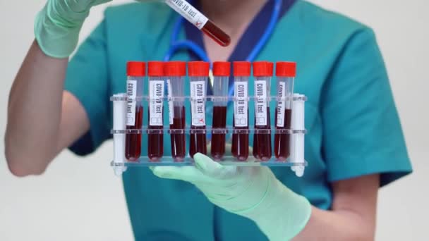 Médico enfermera mujer con máscara protectora y guantes de látex - celebración de estante de tubo de análisis de sangre — Vídeos de Stock