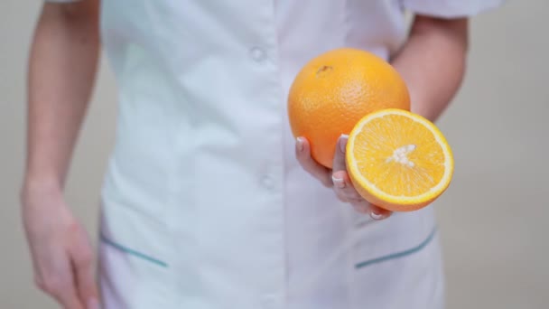 Nutritionist läkare hälsosam livsstil koncept - hålla apelsin frukt — Stockvideo