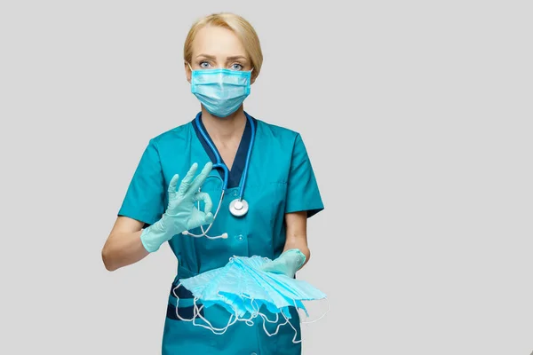 밝은 회색 배경 위로 청진기를 가진 의사 간호사 - 보호용 마스크를 쓴 모습 — 스톡 사진