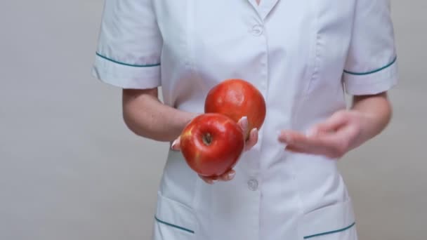 Nutritionist doctor healthy lifestyle concept - holding organic red apple — Stock Video