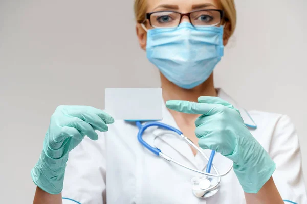 Doctor or woman nurse showing blank empty card with copy space — Stock Photo, Image