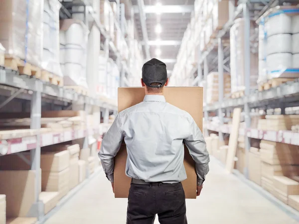 Delivery man in warehouse — Stock Photo, Image