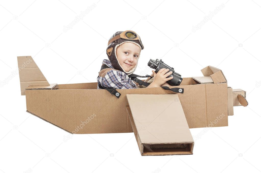child with cardboard airplane