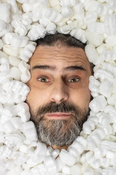 Man covered in polystyrene packaging — Stock Photo, Image
